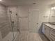Modern bathroom with walk-in shower, granite countertops, and tile flooring at 4051 Dotham St, Port Charlotte, FL 33948