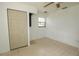 Bright bedroom with tile floors, double closet, and ceiling fan at 20567 Midway Blvd, Port Charlotte, FL 33952