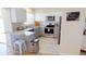 Modern kitchen with gray cabinets, marble countertops, and stainless steel appliances at 22260 Aburto Ln, Port Charlotte, FL 33952