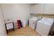 Laundry room with washer, dryer, and ample storage at 22260 Aburto Ln, Port Charlotte, FL 33952