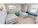 Bright bedroom with twin beds, window seat, and cheerful bedding at 22260 Aburto Ln, Port Charlotte, FL 33952