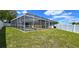 Spacious backyard showcasing a screened pool area at 22260 Aburto Ln, Port Charlotte, FL 33952
