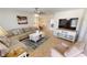 Spacious living area with sectional sofa, large TV, and ample natural light at 22260 Aburto Ln, Port Charlotte, FL 33952