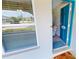Front door entry with teal door and a welcoming mat at 22260 Aburto Ln, Port Charlotte, FL 33952