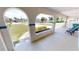 Covered porch with brick planters and seating, offering a relaxing outdoor space at 22260 Aburto Ln, Port Charlotte, FL 33952