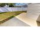 Concrete patio adjacent to the house and fence at 22260 Aburto Ln, Port Charlotte, FL 33952