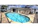 Inviting screened pool area with patio furniture and grill at 22260 Aburto Ln, Port Charlotte, FL 33952