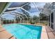 Inviting screened-in pool with a large backyard at 20567 Midway Blvd, Port Charlotte, FL 33952