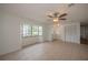 Living room with tile floors, bay window, and ceiling fan at 20567 Midway Blvd, Port Charlotte, FL 33952