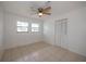Bright bedroom with tile floors and ceiling fan at 20567 Midway Blvd, Port Charlotte, FL 33952