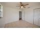 Bedroom with tile floors, ceiling fan, and double closet at 20567 Midway Blvd, Port Charlotte, FL 33952