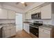Kitchen with stainless steel appliances and granite countertops at 20567 Midway Blvd, Port Charlotte, FL 33952