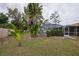 Relaxing backyard oasis with screened pool and lush landscaping at 20567 Midway Blvd, Port Charlotte, FL 33952