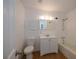 Bathroom with white vanity, tub, and tile floors at 20567 Midway Blvd, Port Charlotte, FL 33952
