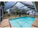 Relaxing screened-in pool area with lush landscaping at 20567 Midway Blvd, Port Charlotte, FL 33952
