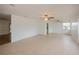 Bright living room with tile flooring, ceiling fan, and large windows at 20567 Midway Blvd, Port Charlotte, FL 33952