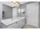 Bright bathroom with double vanity and grey walls at 5115 Melbourne St # A303, Port Charlotte, FL 33980