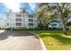 3-story building with balconies and lush landscaping at 5115 Melbourne St # A303, Port Charlotte, FL 33980