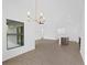 Open dining area with tile flooring and modern chandelier at 12550 Mohican Ave, Port Charlotte, FL 33953
