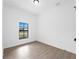 Bright bedroom with tile floors and a large window at 12550 Mohican Ave, Port Charlotte, FL 33953