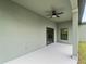 Covered patio with ceiling fan and sliding glass door access to the interior at 12550 Mohican Ave, Port Charlotte, FL 33953
