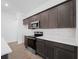 Modern kitchen with dark cabinetry, white countertops, and stainless steel appliances at 12550 Mohican Ave, Port Charlotte, FL 33953