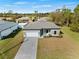 Single-Gathering home with a two-car garage and paver driveway at 12550 Mohican Ave, Port Charlotte, FL 33953