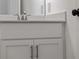 Bathroom vanity with white cabinets, quartz countertop, and brushed nickel faucet at 12550 Mohican Ave, Port Charlotte, FL 33953