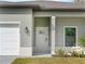 Modern front door with glass accents and sleek door hardware at 12550 Mohican Ave, Port Charlotte, FL 33953