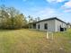 View of the home's rear elevation and backyard, highlighting the landscaping at 12550 Mohican Ave, Port Charlotte, FL 33953