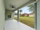 Covered patio with ceiling fan, providing an outdoor space for relaxation at 12550 Mohican Ave, Port Charlotte, FL 33953