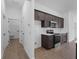Modern kitchen featuring dark cabinetry, tile backsplash, and stainless steel appliances at 12550 Mohican Ave, Port Charlotte, FL 33953