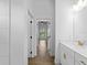 Bathroom hallway with access to bedrooms and double vanity bathroom at 12550 Mohican Ave, Port Charlotte, FL 33953