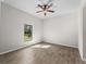 Spacious bedroom with large window, ceiling fan, and tile floors at 1417 Longson St, Port Charlotte, FL 33953