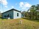 Teal house exterior showcasing the side yard and landscaping at 1417 Longson St, Port Charlotte, FL 33953