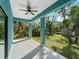 Covered back patio with ceiling fan and view of backyard at 1417 Longson St, Port Charlotte, FL 33953