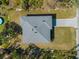 Top-down aerial view of a house showcasing its gray roof and paver driveway at 1417 Longson St, Port Charlotte, FL 33953