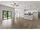 Open living room and kitchen with tile floors and sliding glass doors at 1417 Longson St, Port Charlotte, FL 33953