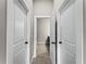 Hallway with doors leading to bedrooms and bathroom at 1417 Longson St, Port Charlotte, FL 33953