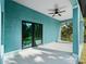Covered back patio with sliding glass doors and ceiling fan at 1417 Longson St, Port Charlotte, FL 33953