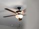 Modern ceiling fan with dark wood blades and a frosted glass light fixture at 1417 Longson St, Port Charlotte, FL 33953