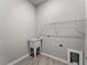 Bright laundry room with utility sink and shelving at 1417 Longson St, Port Charlotte, FL 33953