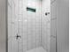 Walk-in shower with white tile and window for natural light at 1417 Longson St, Port Charlotte, FL 33953