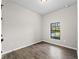Simple bedroom with gray walls, tile floors, and a window at 1417 Longson St, Port Charlotte, FL 33953
