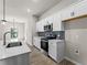 Modern kitchen with white cabinets, tile backsplash, and stainless steel appliances at 1417 Longson St, Port Charlotte, FL 33953