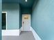 Front entryway with white door and teal walls at 1417 Longson St, Port Charlotte, FL 33953