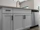 Modern kitchen island with white cabinets and black hardware at 1417 Longson St, Port Charlotte, FL 33953