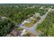 Aerial view of a home surrounded by lush greenery in a residential neighborhood at 3376 Dunbar St, Port Charlotte, FL 33948