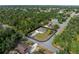 Aerial view of house on a corner lot, surrounded by lush trees at 3376 Dunbar St, Port Charlotte, FL 33948