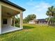 Expansive backyard view of a house with solar panels and a covered patio, perfect for outdoor enjoyment at 3376 Dunbar St, Port Charlotte, FL 33948